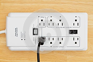 A power surge protector on wood