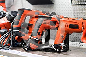 Power tools, drills and hammers of various manufacturers are sold in a hardware store. photo