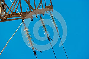 Power tower detail with three row od glass insulators and the wires