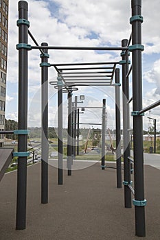 Power trainer for hand muscles from the rungs of the tracks on the Playground in the city outdoors.