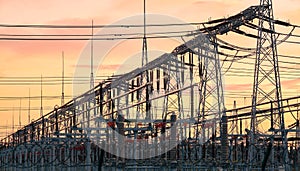 Power transmission infrastructure silhouettes at sunset