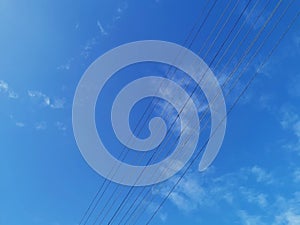 Power transmission lines against deep blue sky with copy space