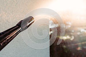 Power washing the wall - cleaning the facade of the house - focus on the tip of the spray nozzle