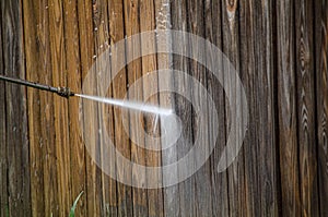 Power washing a wooden fence