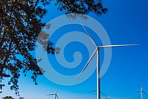 Power of wind turbine generating electricity clean energy with cloud background on the blue sky.Global ecology.Clean energy
