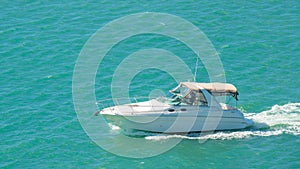 Powerboat or motorboat. Fishing boat on ocean waves. Ocean or Gulf of Mexico. Spring break or Summer vacations in Florida. Blue-tu