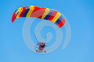 Powered Paraglider in a blue sky