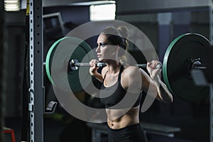 Powerful attractive muscular woman CrossFit trainer do workout with barbell