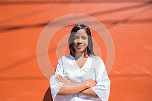 Powerful and confident woman on a colorful wall