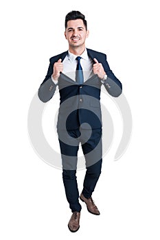 Powerful and confident young businessman opening his suit jacket