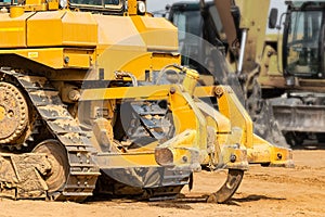 Powerful crawler bulldozer close-up at the construction site. Construction equipment for moving large volumes of soil. Modern