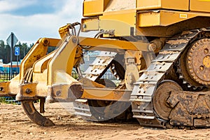 Powerful crawler bulldozer close-up at the construction site. Construction equipment for moving large volumes of soil. Modern