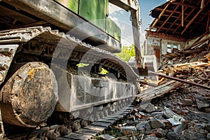 Powerful crawler excavator demolishes an old building
