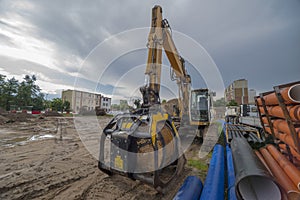 A large construction site in the rain. Large excavator with soil fractionation device.