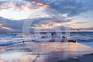 Powerful crushing waves and wooden pier in Austrlaia.