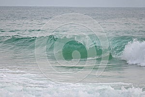 A powerful crystal green ocean wave on a beautiful beach, Phuket, Thailand