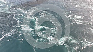 Powerful current forms small whirlpools and eddies in ocean water