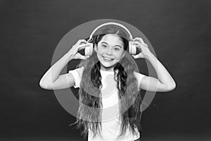 Powerful effect music teenagers their emotions, perception of world. Girl listen music headphones on red background