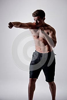 Powerful fighter man in fighting stance