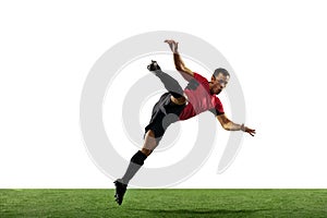 Young football, soccer player of team in action, motion isolated on white background. Concept of sport, movement, energy