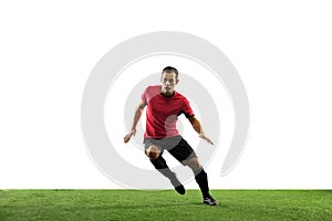 Young football, soccer player of team in action, motion isolated on white background. Concept of sport, movement, energy