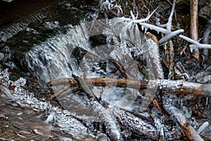 Powerful growths of ice from water splashes on the creek