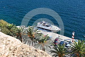 Powerful high-speed boat at the pier on the background of trees