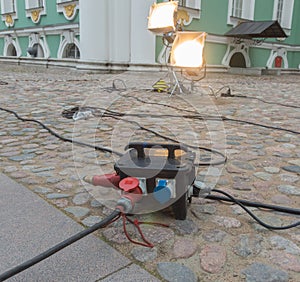 Powerful hooks extension cords near a historic building.