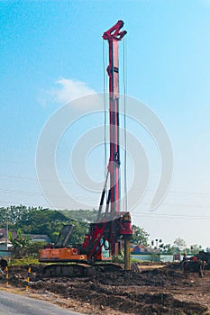Powerful hydraulic machine drilling rig on a construction site. Installation of bored piles by drilling. Pile foundations.