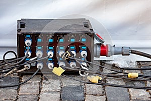 A powerful industrial electrical extension with 18 sockets for outdoor use at concerts and events. Cables are connected. Equipment