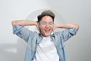 Powerful, joyful Asian man smiling on white background