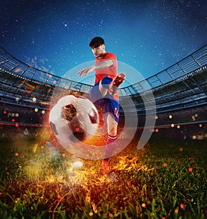 Powerful kick of a soccer player with fiery ball photo