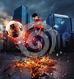 Powerful kick of a soccer player with fiery ball photo