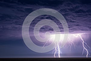 Powerful lightning bolts strike from a summer thunderstorm.