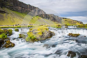 Powerful and magestic waterfall with volcanic rock in an Icelandic landscape2