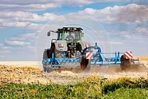 Powerful modern machine for harvesting from the field.  Golden field of ears, barley, wheat and rye, harvesting equipment against