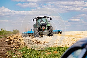 Powerful modern machine for harvesting from the field.  Golden field of ears, barley, wheat and rye, harvesting equipment against