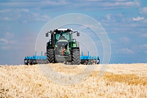 Powerful modern machine for harvesting from the field.  Golden field of ears, barley, wheat and rye, harvesting equipment against