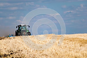 Powerful modern machine for harvesting from the field.  Golden field of ears, barley, wheat and rye, harvesting equipment against