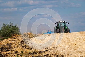 Powerful modern machine for harvesting from the field.  Golden field of ears, barley, wheat and rye, harvesting equipment against