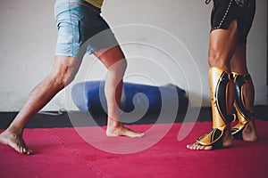Powerful Muay Thai fighters' legs, shielded by shin guards.