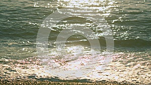 Powerful And Peaceful Nature Concept. Sun Light Reflecting Or Sparkling Glitter On Water Of Sea Or Ocean. Slow motion.