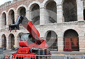 powerful red crane for handling weight loads during the preparation of the events and the ARENA in the background photo