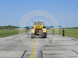 Powerful Russian military jet fighter plane on the runway of the SU-34 tractor carries engine