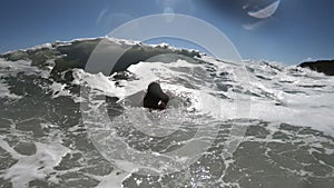 Powerful sea waves splashing on a cheerful woman body