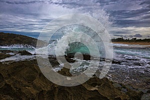 Powerful splash against rock formations