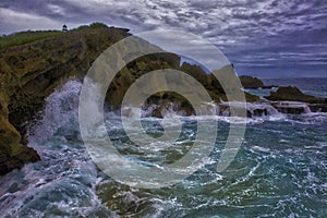 Powerful splash against rock formations