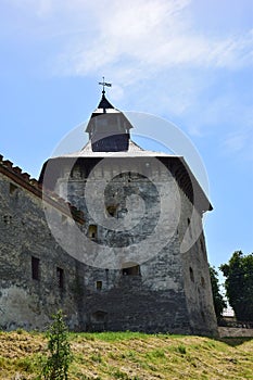 A powerful stone wall of a medieval fortress with many loopholes and embrasures