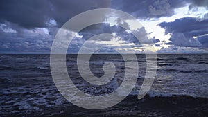 Powerful strong waves are moving across the sea against the background of a stormy sky