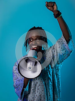 In a powerful and symbolic image, an African American man wears traditional clothing, passionately wields a megaphone
